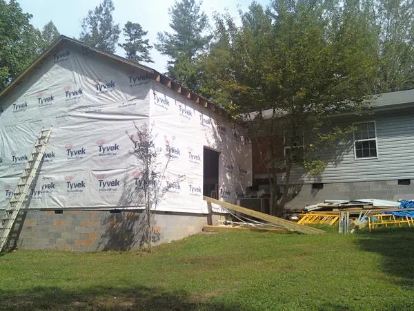 Tyvek wrapped gable on a new room addition beside an existing home in Bell